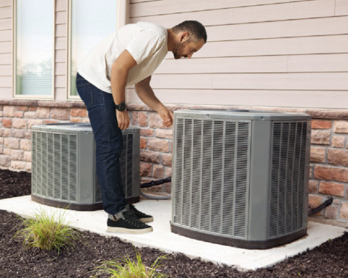 Homeowner Outside By Air Conditioner