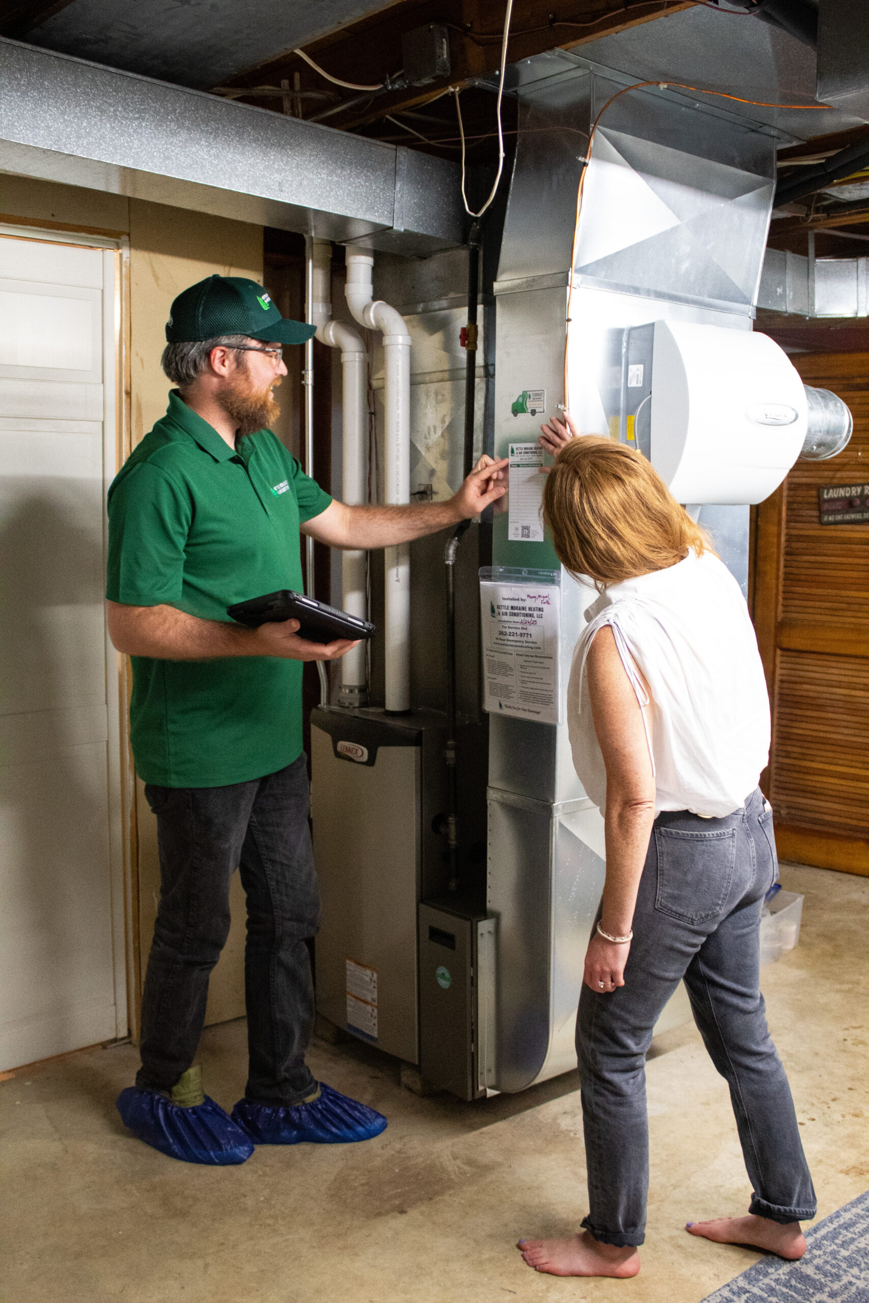 kettle moraine heating tech with homeowner